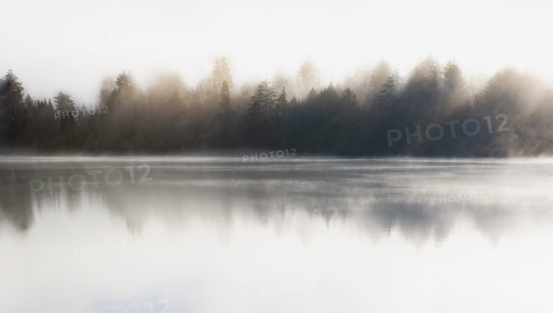 Morning mist on Mirror Lake. Lake Placid, New York State, USA.