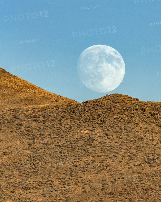 Moon rising over rocky hillside. Bellevue, Idaho, USA.