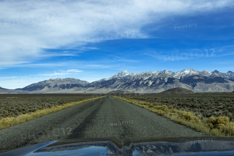 Empty rural road over Trail Creek Pass seen from vehicle. Mackay, Idaho, USA.