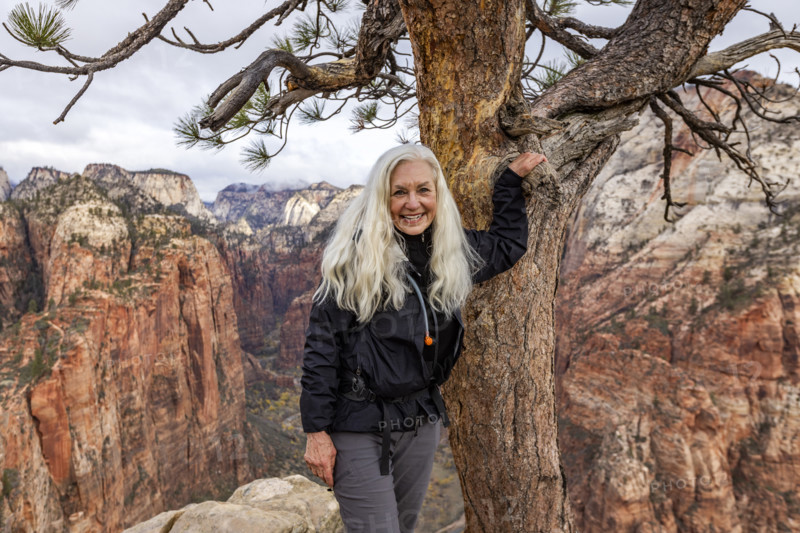 Portrait of senior blonde woman on Angels Landing. , Utah, USA.