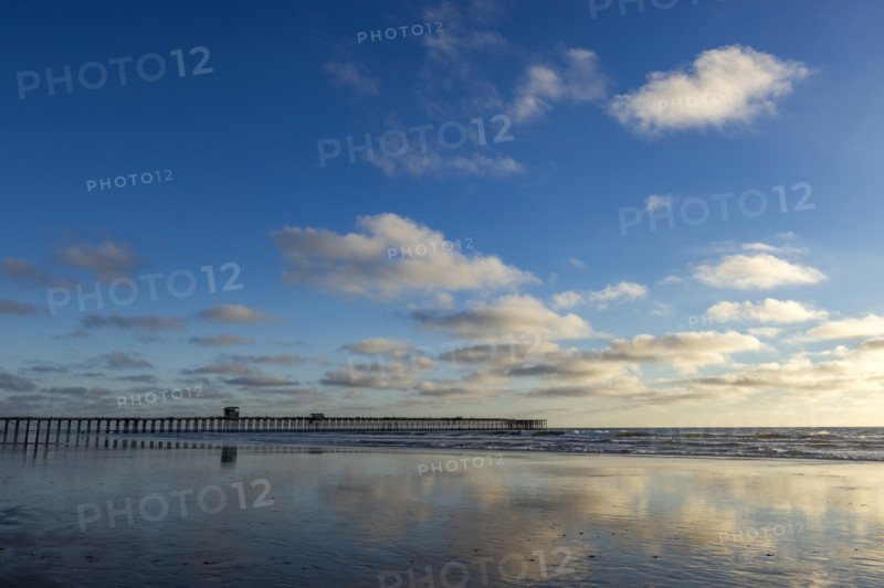 Oceanside Pier and calm ocean in late afternoon. Oceanside, California, USA.