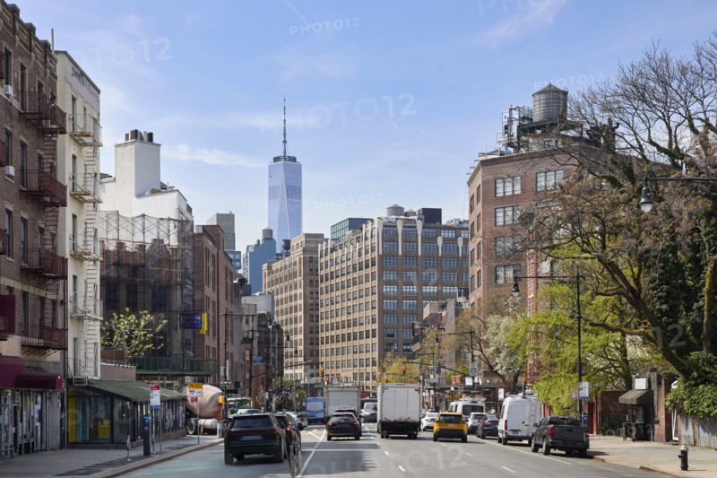 Traffic on street with One World Trade Center in background. New York City, New York State, USA.