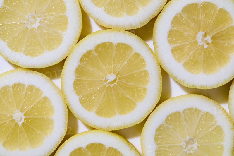 Close-up of sliced lemons on white background. New York City, New York State, USA.