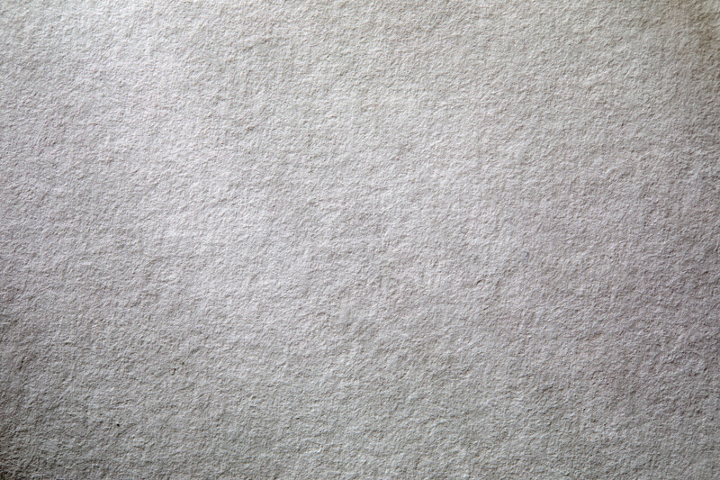 Dappled light on textured white paper. New York City, New York State, USA.