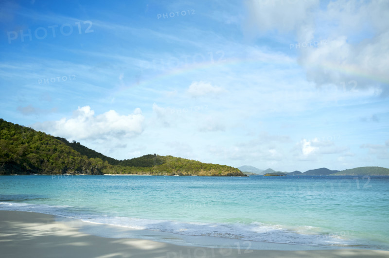 Rainbow over turquoise water of Trunk Bay. New York City, New York State, USA.
