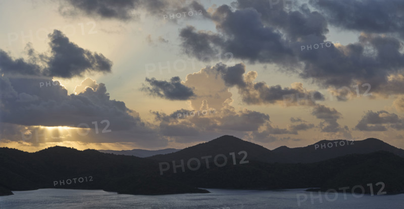 Clouds over mountains and ocean at sunrise. New York City, New York State, USA.