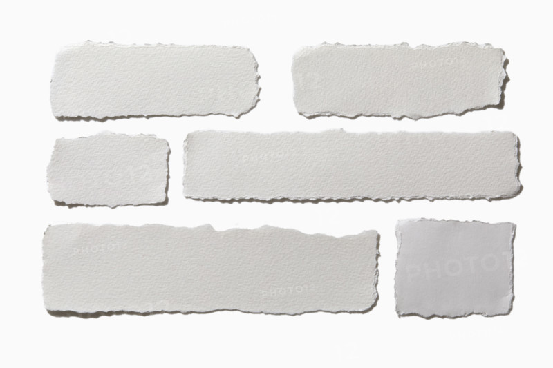 Pieces of torn paper on white background. New York City, New York State, USA.