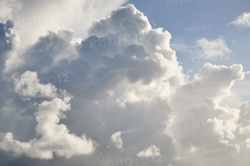 White puffy cumulous clouds and blue sky. New York City, New York State, USA.