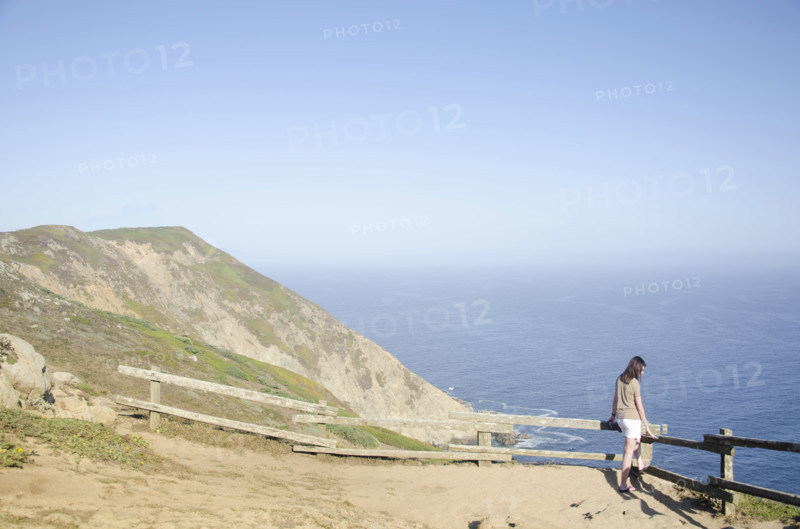 Woman looking at view at Point Reyes National Seashore, Inverness, California, USA.
