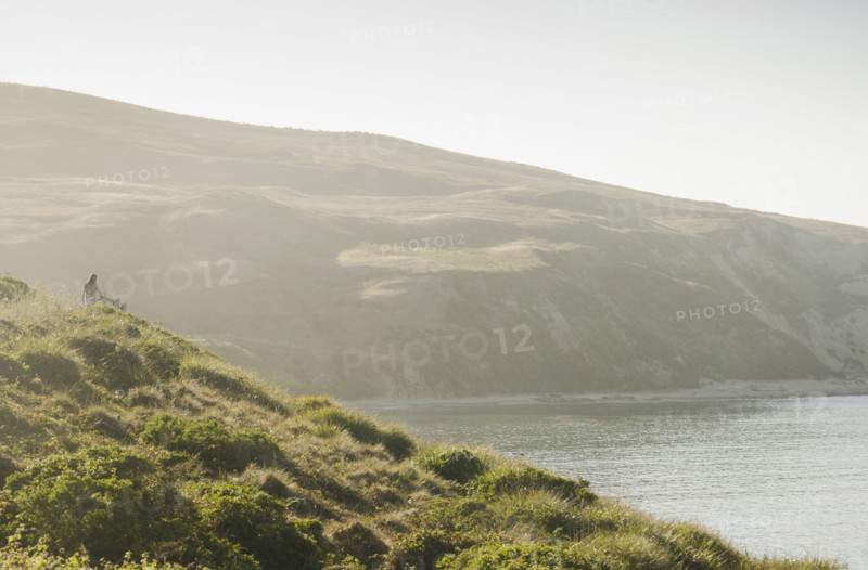 Rear view of woman on path at Drakes Bay, Inverness, California, USA.