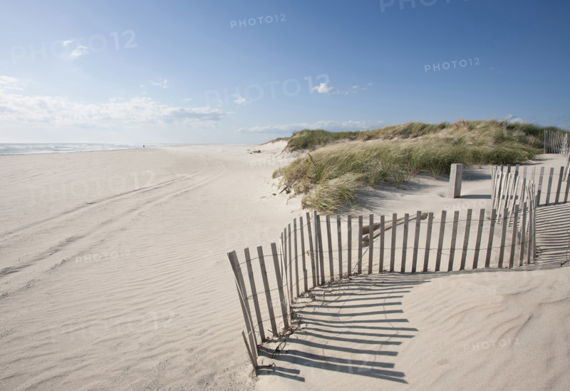 Fence on empty Madaket Beach on sunny day, Nantucket, Massachusetts, USA.