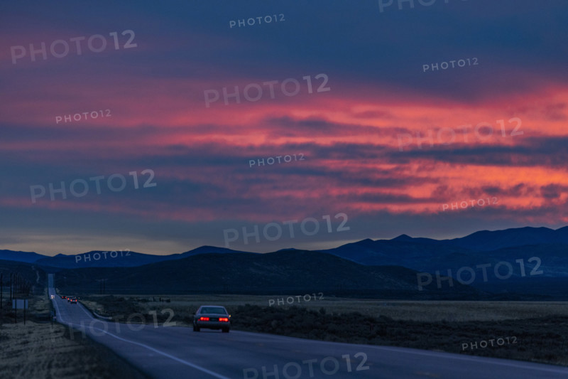 Car on highway 20 at sunrise, Belleuve, Idaho, USA.