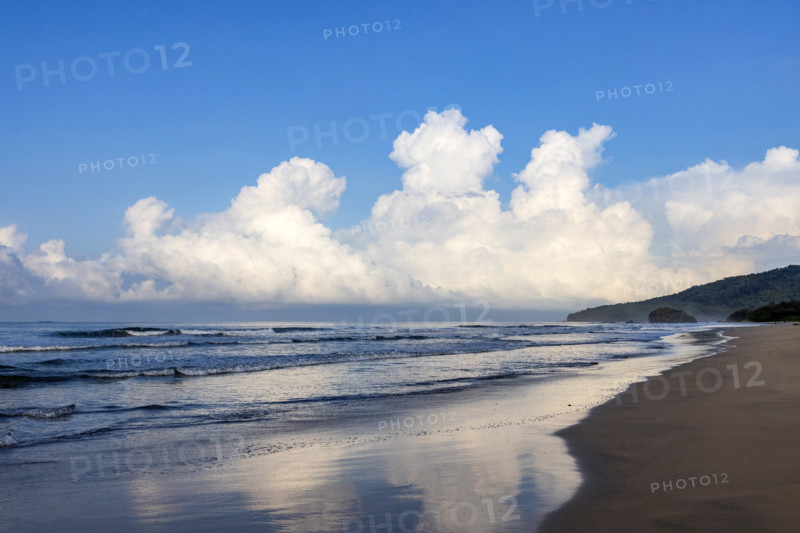 Sky and clouds reflecting in calm sea surface at dawn, Playa Grande, Guanacaste, Costa Rica.