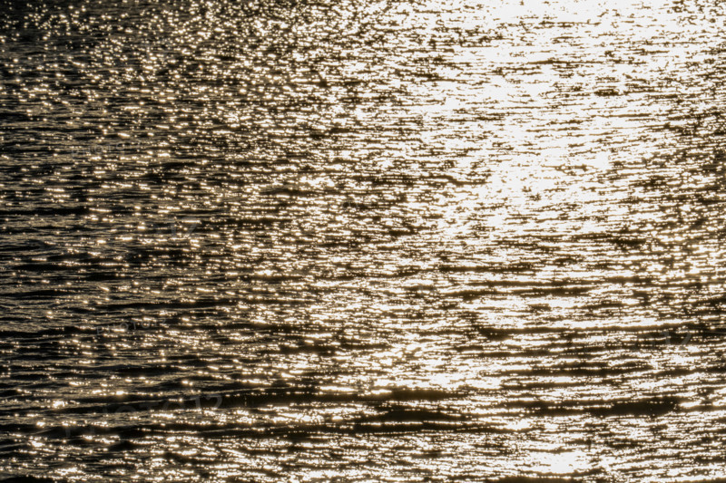Sunlight reflected in rippled water surface, Bellevue, Idaho, USA.