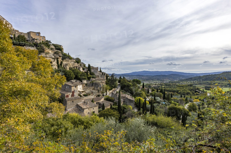 Old houses and trees in Luberon Valley, Gordes, Vaucluse, France.