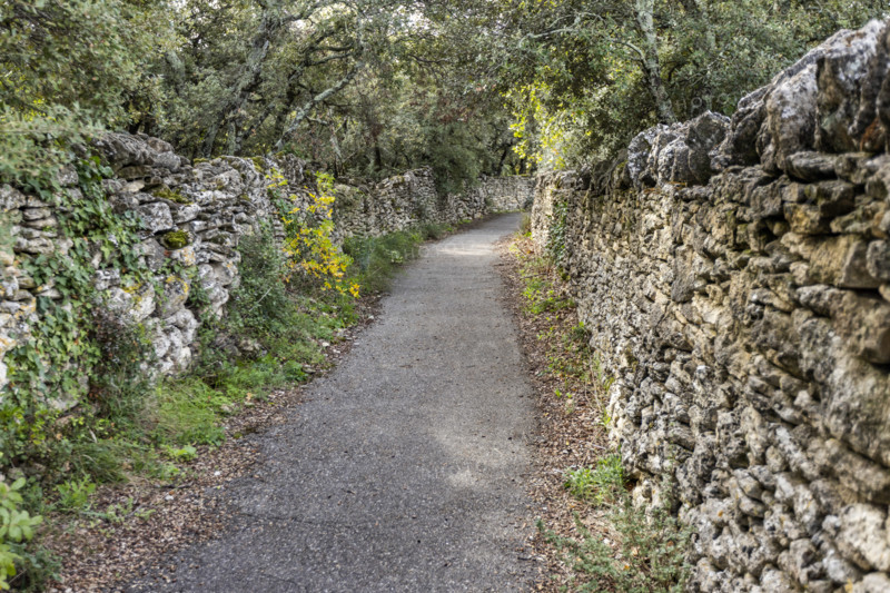 Empty path between old stone walls, Gordes, Vaucluse, France.
