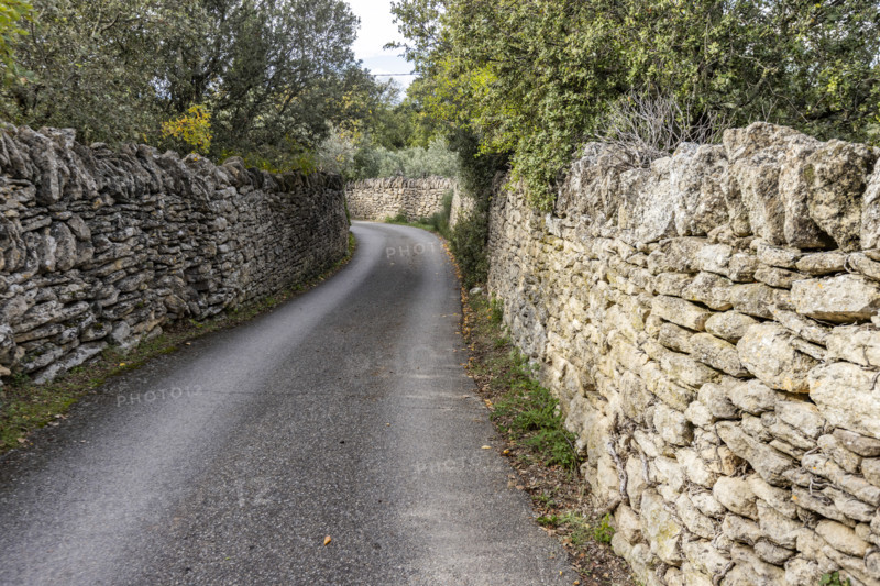 Empty path between old stone walls, Gordes, Vaucluse, France.
