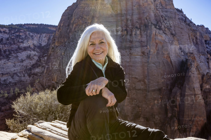 Portrait of smiling senior woman atop Angels Landing, Zion National Park, Utah, USA.