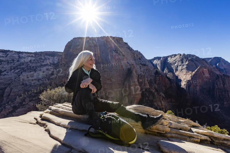 Smiling senior woman atop Angels Landing, Zion National Park, Utah, USA.