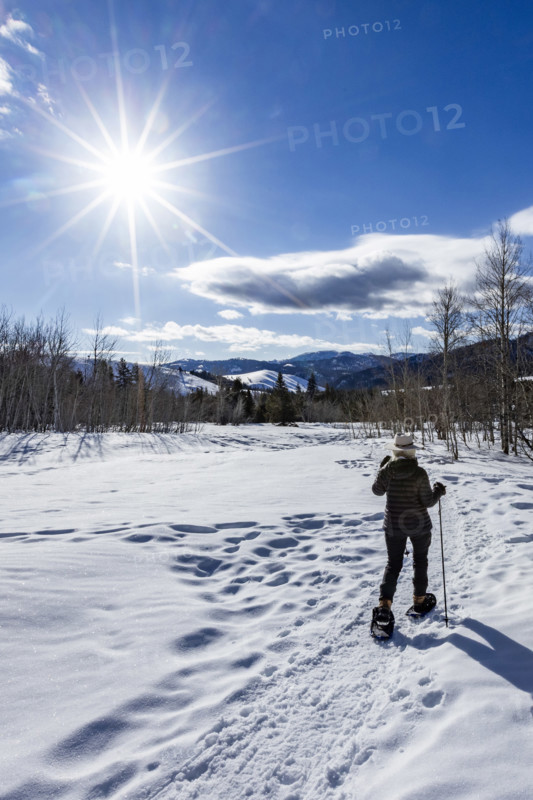 Rear view of senior woman snowshoeing in Sun Valley, Sun Valley, Idaho, USA.