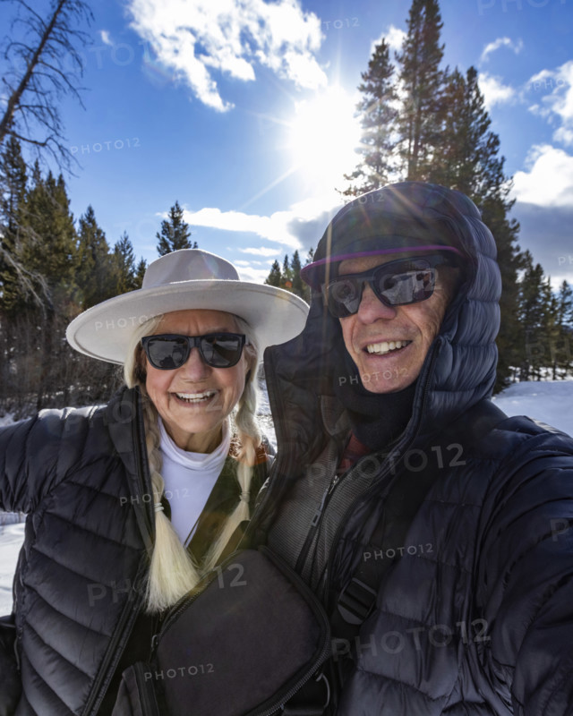 Portrait of smiling senior couple snowshoeing in Sun Valley, Sun Valley, Idaho, USA.