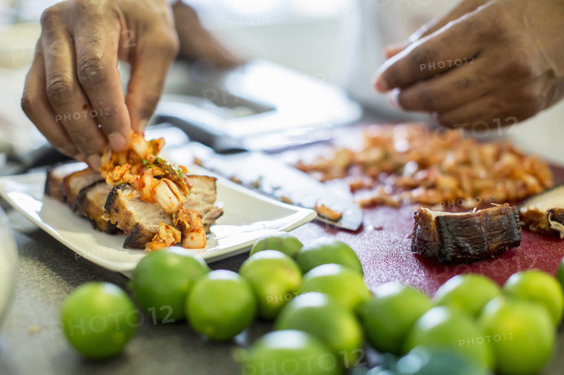 Close-up of chef making pork belly and kimchee in restaurant, Los Angeles, California, USA.