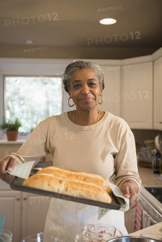 Portrait of smiling woman baking in kitchen, Richmond, Virginia, USA.