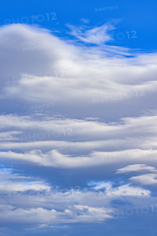 White lenticular clouds on blue sky