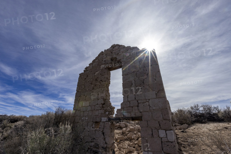Sun shining through abandoned church in desert