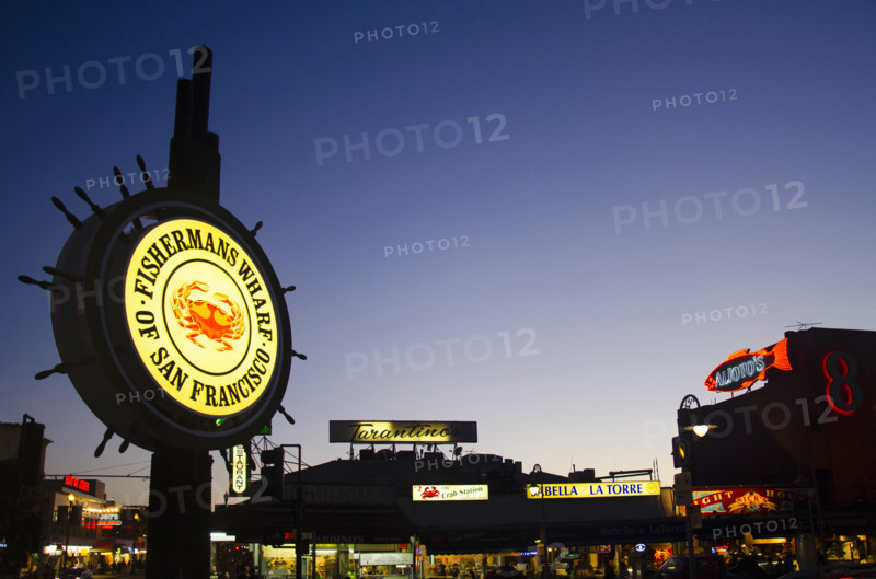 Illuminated signs at Fisherman's Wharf at twilight