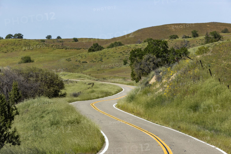 Empty winding road through hills
