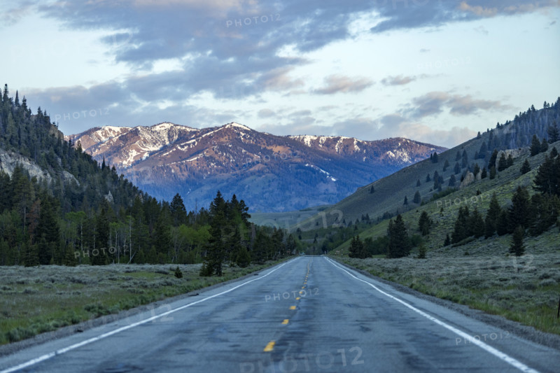 Empty highway 75 with mountains in distance at sunset