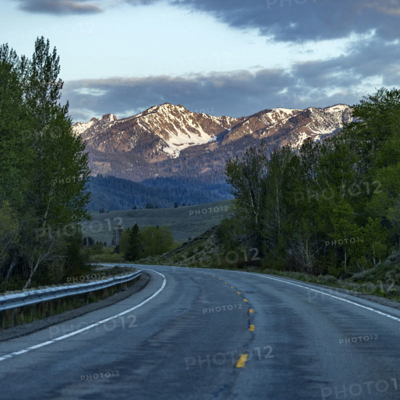 Empty highway 75 with mountains in distance at sunset
