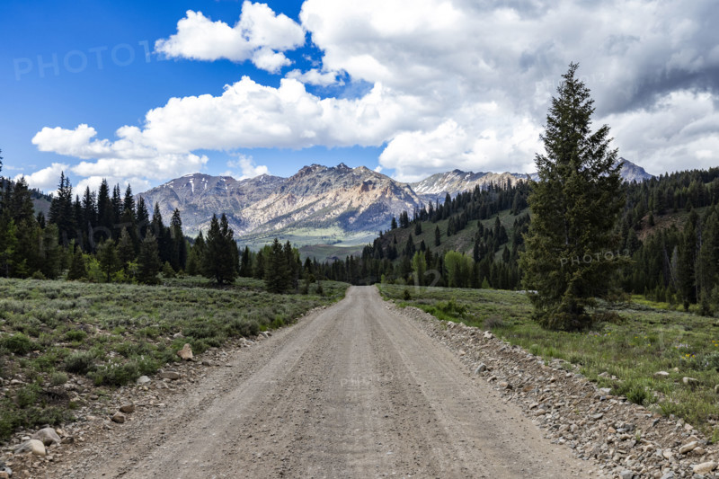 Empty dirt road leading to mountains