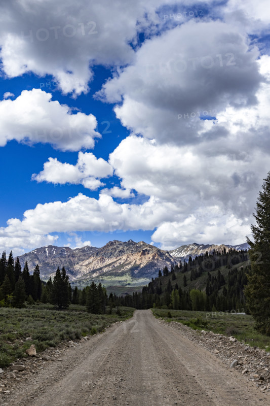 Empty dirt road leading to mountains