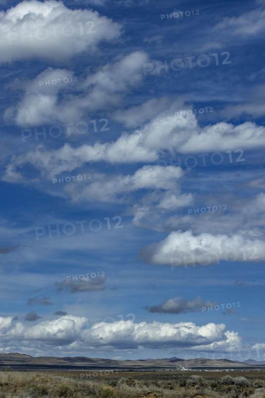 Clouds above grassy fields