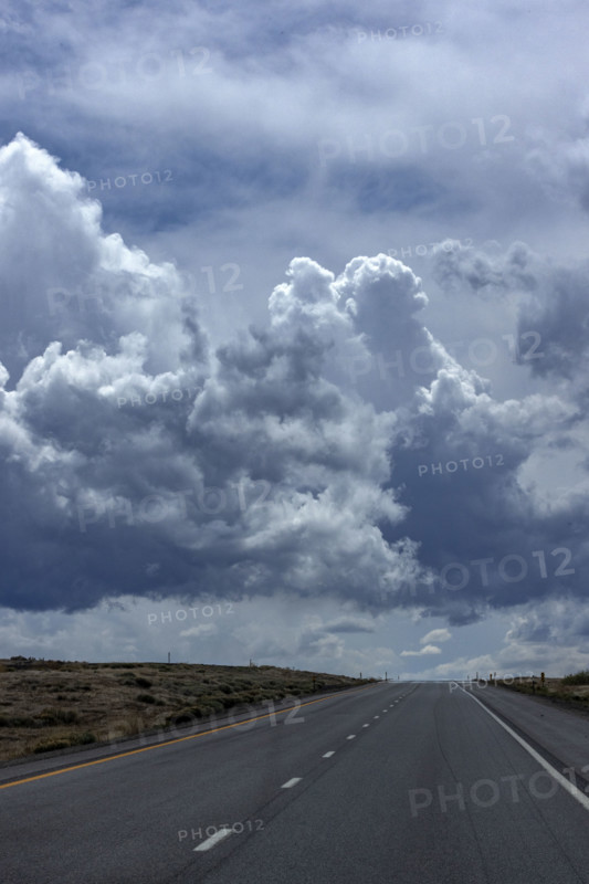 Dramatic sky above empty desert highway