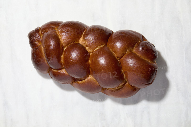 Overhead view of Challah bread on white background