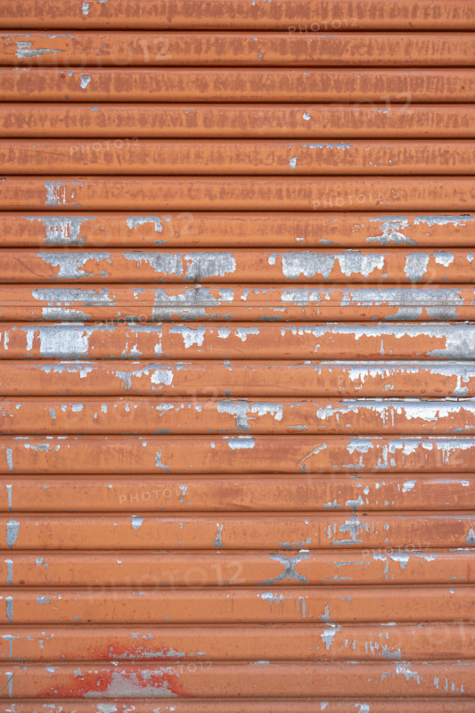 Close-up of old orange metal door