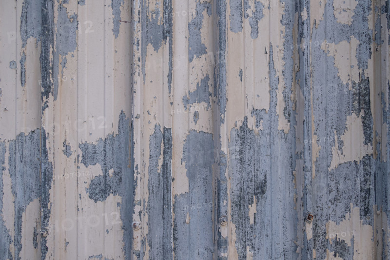 Close-up of metal wall with peeling paint