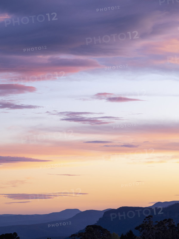 Pink and orange clouds against blue sky