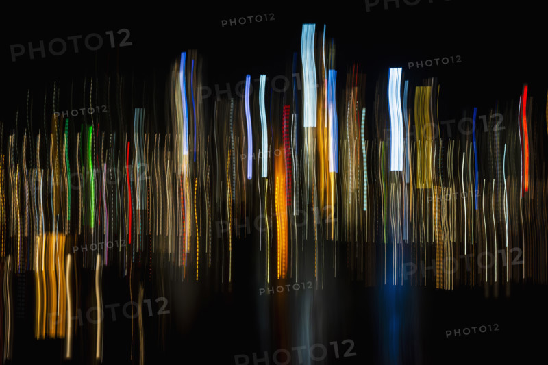 Vertical light trails on dark background