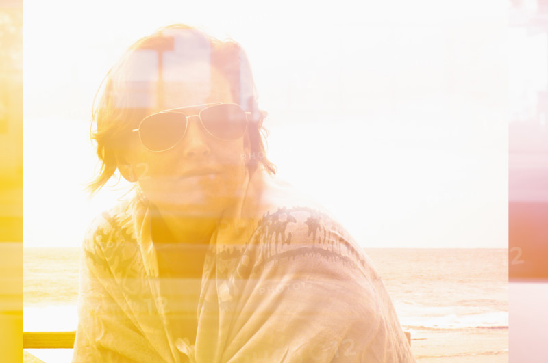 Composite image of woman with sunglasses looking to side