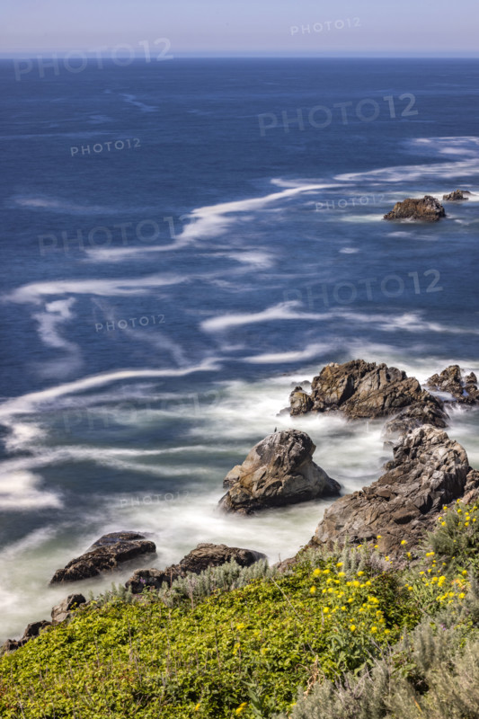 Water swirling around rocks, motion blur