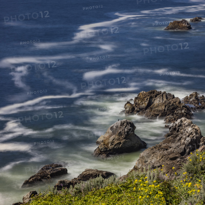Water swirling around rocks, motion blur