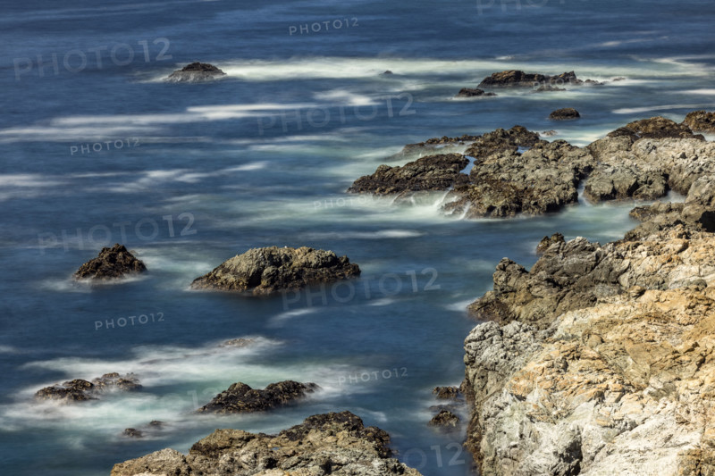 Water swirling around rocks, motion blur