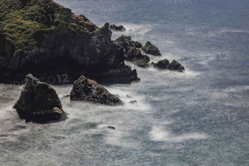Water swirling around rocks, motion blur