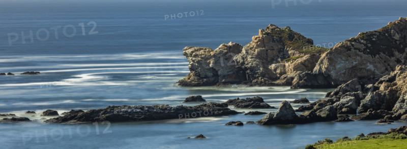 Water swirling around rocks, motion blur