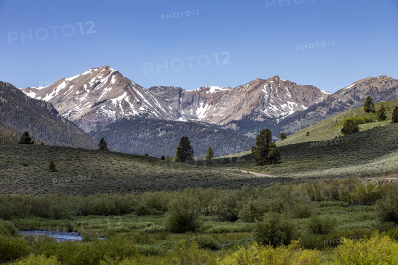Green valley and mountains with snow