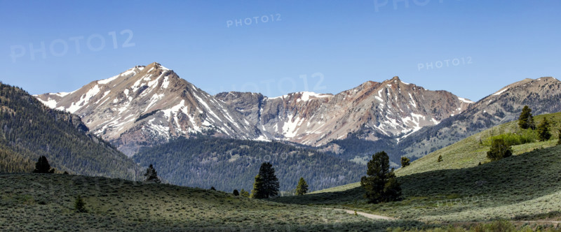 Green valley and mountains with snow